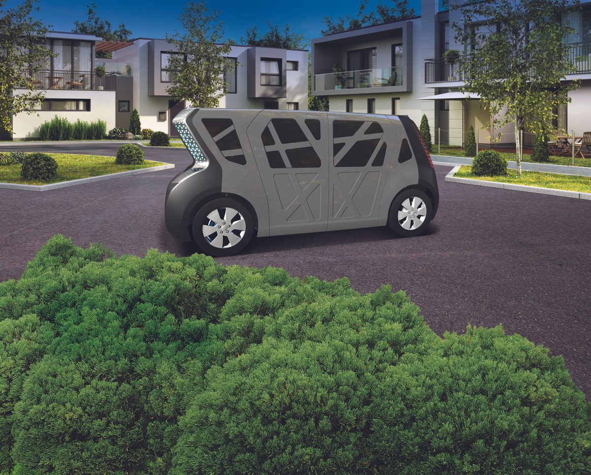 Steel E-Motive Vehicle is shown in a brick paved area with greenery