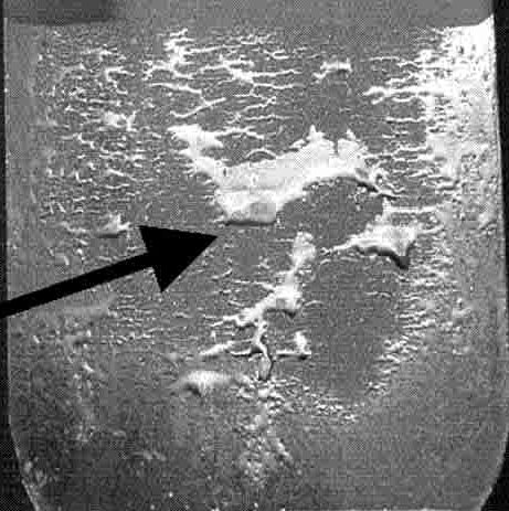 Figure 1: Poor wettability after galvanizing. SiO2 covers the surface in the bare areas, while the sparse areas covered with zinc correspond to reaction areas with an interfacial Fe2Al5 layer in between the zinc and steel. Modified from Citation D-49. https://ahssinsights.org/citations/d-49/